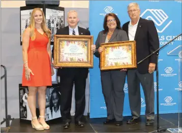  ?? ELISHA MORRISON/The Saline Courier ?? Emmy Rogers, director of developmen­t for the Boys & Girls Clubs of Saline County, left, and Board President Jim Handley, right, present the speakers of the Clubs Golden Jubilee Breakfast — Lt. Governor Tim Griffin, second from left, and National Vice President of Boys & Girls Clubs of America Teresa Walch, second right — with custom paintings provided by local artist Matt Coburn at the conclusion of the celebratio­n breakfast Thursday.