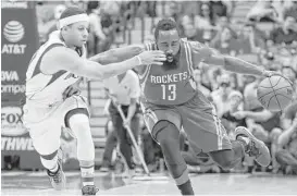  ?? LM Otero / Associated Press ?? The Rockets’ James Harden fends off the Mavericks’ Seth Curry during the first half Wednesday night.