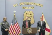  ?? Martha Asencio-Rhine Tampa Bay Times ?? U.S. ATTY. Roger Handberg, f lanked by Police Chief Anthony Holloway, left, and FBI Agent David Walker, discusses a Russian operative in St. Petersburg, Fla.