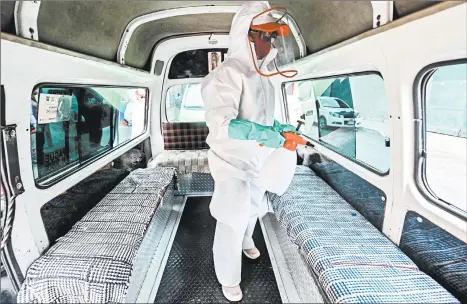  ?? PEDRO PARDO/GETTY-AFP ?? A worker wearing personal protective equipment disinfects a public transport van Thursday in Mexico City. Mexico now ranks No. 3 for the most COVID-19 deaths in the world.