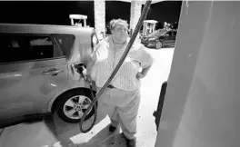  ?? RICH POPE/ORLANDO SENTINEL ?? Gabby Alcantara-Anderson puts gas in her car at a 7-Eleven on Disney property after a long day of work in September at Magic Kingdom. Alcantara-Anderson has spent nearly a decade at Disney and earned promotions, yet she and her family still struggle.