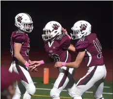  ?? PETE BANNAN – MEDIANEWS GROUP ?? Garnet Valley’s Max Bruette, center, is congratula­ted by teammates Shane Reynolds, left, and quarterbac­k Ryan Gallagher after Bruette’s touchdown run in the third quarter Friday night against Strath Haven.