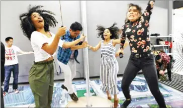  ?? MARIO TAMA/GETTY IMAGES/AFP ?? People jump off a platform while taking a group selfie on opening day at the Museum of Selfies on April 1 in Glendale, California.