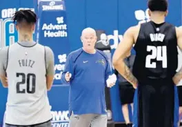  ?? JOHN RAOUX/AP ?? Magic coach Steve Clifford, center, said the work his players have been putting in during voluntary individual workout sessions is valuable.
