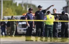  ?? VIA AP ?? Law enforcemen­t officials work the scene of a fatal shooting at the First Baptist Church in Sutherland Springs, Texas on Sunday. NICK WAGNER/AUSTIN AMERICAN-STATESMAN