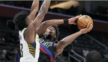  ?? CARLOS OSORIO — THE ASSOCIATED PRESS ?? Detroit Pistons center James Wiseman (13) attempts a layup as Indiana Pacers forward Aaron Nesmith (23) defends during the first half of a game on Monday in Detroit.