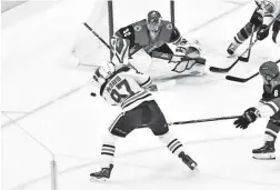  ??  ?? Oilers center Connor McDavid shoots against Coyotes goaltender Antti Raanta (32) in Glendale on Tuesday night.