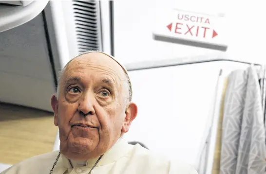  ?? GUGLIELMO MANGIAPANE • REUTERS POOL ?? Pope Francis holds a news conference aboard the papal plane on his flight back to The Vatican on Friday after visiting Canada. During the conference, he acknowledg­ed that the abuses suffered by Indigenous people at residentia­l schools in Canada amounted to genocide.