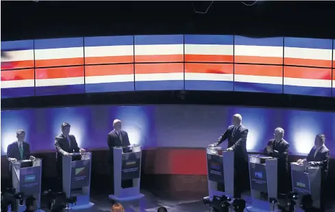  ??  ?? MAY THE BEST MAN WIN: Presidenti­al candidates stand on the stage before a live, televised debate ahead of the presidenti­al election, in San Jose, Costa Rica, on Thursday.
