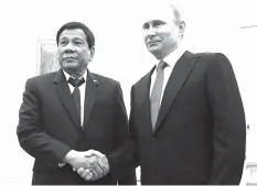  ?? ASSOCIATED PRESS ?? Russian President Vladimir Putin (right) shakes hands with President Rodrigo Duterte during their meeting at the Kremlin in Moscow.