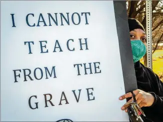  ?? STEVE SCHAEFER/ FOR THE AJC ?? Teacher Amber Horton protests along with others Dec. 29 in front of the Dekalb County School District offices in Stone Mountain.