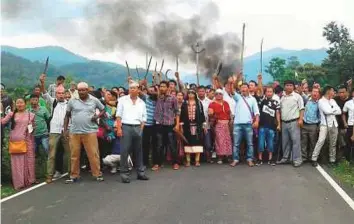  ??  ?? Supporters of the Gorkha Janmukti Morcha block a road at Panighata in Siliguri yesterday during their protest in support of the demand for a separate state of Gorkhaland. Yesterday, a minister’s convoy was allegedly stopped and attacked when he was on...