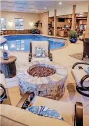  ??  ?? The fire pit and pool area in the Symphony Show House at 4808 Rose Rock Drive: Furniture by Rosinna Gies, of Amini’s Galleria; plants by Abbie Wilkerson, of Calvert’s; in back, kitchen by Renae Brady, of Lorec Ranch.