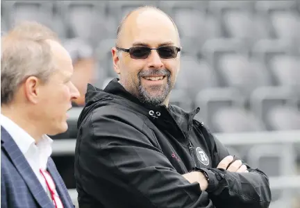  ?? JULIE OLIVER ?? Redblacks general manager Marcel Desjardins, right, says there’s no benefit to stringing along players who clearly won’t make the team.