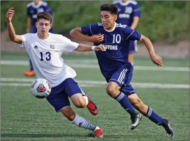  ?? Katharine Lotze/The Signal ?? Fullerton’s Carlos Esparza (13) reaches in front of College of the Canyons’ Cesar Dominguez (10) as they fight for control of the ball during a soccer game at COC on Tuesday.