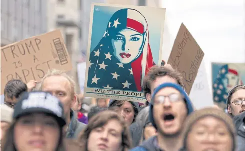  ??  ?? THE FIGHT GOES ON: Demonstrat­ors march on the street near a security checkpoint ahead of Donald Trump’s inaugurati­on as US president in Washington.