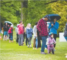  ?? JASON PAYNE/POSTMEDIA ?? People keep their distance while waiting in line to attend the Trout Lake Farmers Market on Saturday. The market was deemed an essential service.