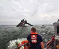  ?? AP FILE ?? TRAPPED: A Coast Guard response boat approaches the Seacor Power, which capsized in the Gulf of Mexico earlier this week. As of Friday, 11 crew members were missing and believed trapped in the oil rig servicing ship.