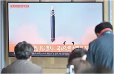  ?? — AFP ?? This file picture taken on May 4 shows people watching a television screen showing a news broadcast with file footage of a North Korean missile test, at a railway station in Seoul.