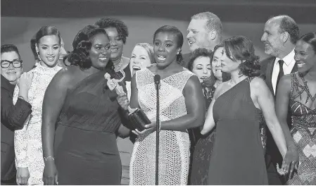  ??  ?? Uzo Aduba, center, and the cast of "Orange is the New Black" accept the award for outstandin­g performanc­e by an ensemble in a comedy series at the Screen Actors Guild awards in 2015. VINCE BUCCI/INVISION/AP