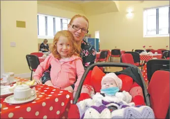  ??  ?? (06_a38ZamScot­Ed02) Four-year-old Lily with baby Natalie and mum Annie Galloway from Lochgilphe­ad enjoying a cuppa and a cake and, below, Denise MacLean, left, and (06_a38ZamScot­Ed01) Marian Pallister among the workers at the coffee morning.