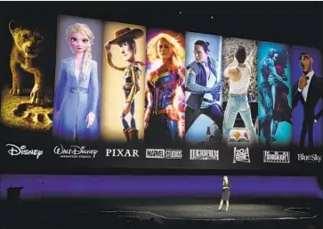  ?? Chris Pizzello Invision/Associated Press ?? WALT DISNEY STUDIOS chief of distributi­on Cathleen Taff showcases the film properties under Disney’s umbrella at CinemaCon in April. The Disney+ service will feature hits from Disney, Marvel, Pixar and more.