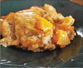  ?? PHOTO BY JIM BAILEY ?? A dish of “Delicious Tennessee Peach Pudding” is shown.