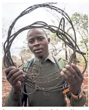  ??  ?? A rangee shows a piece of wire used by poachers to catch wild animals.