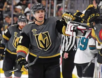  ?? ETHAN MILLER/GETTY IMAGES ?? The Golden Knights’ David Perron celebrates with teammates on the bench after he assisted James Neal on a goal against the Sharks with three seconds left in the first period of Game 5 of the Western Conference semifinals Friday at T-Mobile Arena in Las...