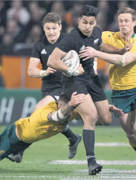  ??  ?? All Blacks winger Rieko Ioane takes on two Wallabies during last night’s nail-biting Bledisloe encounter in Dunedin.