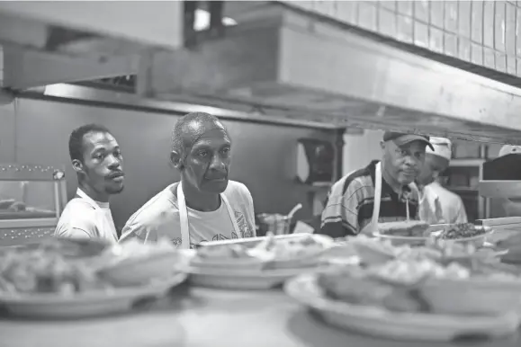  ?? COMMERCIAL APPEAL ?? The kitchen keeps plates moving through the pass during a busy lunch shift Tuesday at Charles Cavallo’s Cupboard Restaurant. PHOTOS BY BRANDON DILL/FOR THE