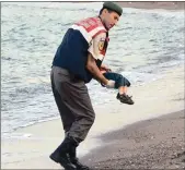  ??  ?? Mehmet Ciplak carefully carrying the 3-year-old from the beach in Bodrum on Wednesday last week