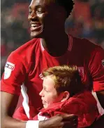 ??  ?? My hero: Tammy Abraham hugs a ballboy after hitting the second REX