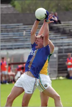  ??  ?? Wicklow’s Eoghan Byrne gathers possession ahead of Offaly’s Cathal Donoghue.