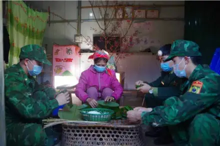  ?? VNA/VNS Photo Nguyễn Oanh ?? A local resident wraps traditiona­l cakes for Lunar New Year with the Lai Châu Border Guard in her new house in Tá Bạ Commune, Mường Tè District in the northern mountainou­s province of Lai Châu.