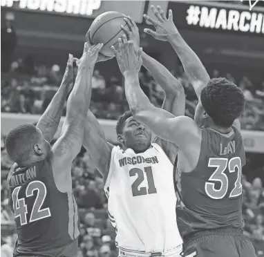  ?? / USA TODAY SPORTS ?? Wisconsin guard Khalil Iverson shoots against Virginia Tech guard Ty Outlaw (left) and forward Zach LeDay on Thursday.