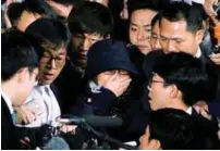  ?? REUTERSPIX ?? Choi (centre) reacts as she is surrounded by media upon her arrival at the prosecutor­s’ office in Seoul yesterday.