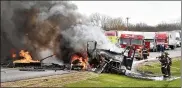  ?? BILL LACKEY / STAFF ?? Members of the Mad River Twp. fire department fight flames after a tractor trailer and car collided on I-70 near the Enon Road entrance in 2015.