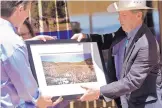  ?? MARLA BROSE/JOURNAL ?? U.S. Sens. Martin Heinrich, left, and Tom Udall, hold a photo of the Sabinoso Wilderness. Each was presented a framed copy of the photo by organizati­ons supporting conservati­on efforts.