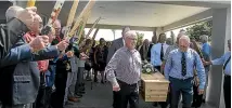  ?? BEJON HASWELL/STUFF ?? Friends form a guard of honour with cricket bats at the funeral for Timaru sportsman John Ward yesterday.