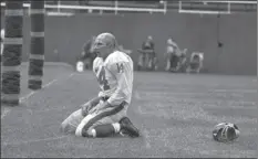  ??  ?? In this Sept. 20, 1964, file photo, New York Giants’ Y.A. Tittle squats on the field after being hit hard while passing during a game against the Pittsburgh Steelers, in Pittsburgh. AP PHOTO/DOZIER MOBLEY