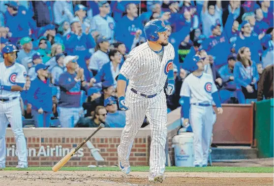  ??  ?? Kyle Schwarber watches his two- run home run in the second inning against the Reds on Saturday at Wrigley Field. The Cubs cruised to a 9- 0 victory. | JON DURR/ GETTY IMAGES