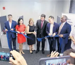  ?? CARLOS VAZQUEZ OTERO/EL SENTINEL ?? Puerto Rico Federal Affairs Administra­tion Executive Director Carlos Mercader and Regional Director Ilia Torres inaugurate the first Integrated Services Center outside of Puerto Rico, along with other Central Florida elected officials.
