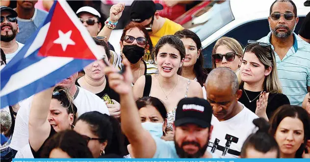  ??  ?? MIAMI: Protesters gather in front of the Versailles restaurant to show support for the people in Cuba who have taken to the streets there to protest on July 11, 2021 in Miami, Florida. —AFP