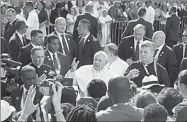  ?? ALESSANDRA TARANTINO/AP ?? In Panama City:Pope Francis blesses pilgrims Saturday as he arrives to celebrate Mass at Santa Maria la Antigua, which is considered the first cathedral of mainland America, during the halfway point of the pontiff ’s four-day visit to Panama for World Youth Day.