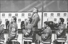  ?? ASSOCIATED PRESS ?? looks up to Dale Hawerchuk as he is honored before NHL Western Conference Stanley Cup playoff action against the Calgary Flames, in Edmonton, Alberta on Tuesday.
OFF THE HELMET AND OUT