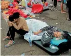  ?? AP ?? Earthquake survivors are treated outside a hospital in Cianjur after an earthquake that killed at least 162 people.