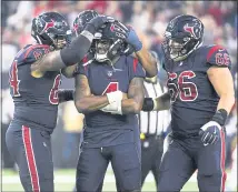  ?? ERIC CHRISTIAN SMITH — THE ASSOCIATED PRESS ?? Teammates celebrate with Texans quarterbac­k Deshaun Watson, center, after Watson threw one of his five touchdown passes.