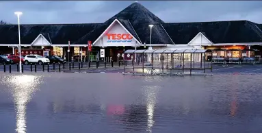  ??  ?? Submerged: A car park at a Tesco branch in Carlisle was swamped by rising floodwater­s