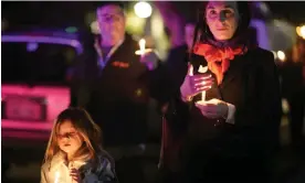  ?? Photograph: Xinhua/REX/Shuttersto­ck ?? Mourners pay respects to the victims of the shootings in Half Moon Bay in California in January 2023.